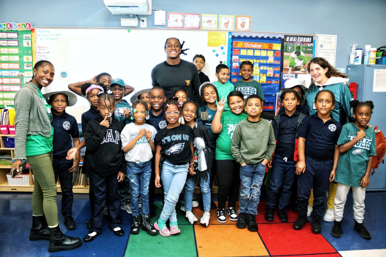 AFPCS students and staff smile for a classroom photo.