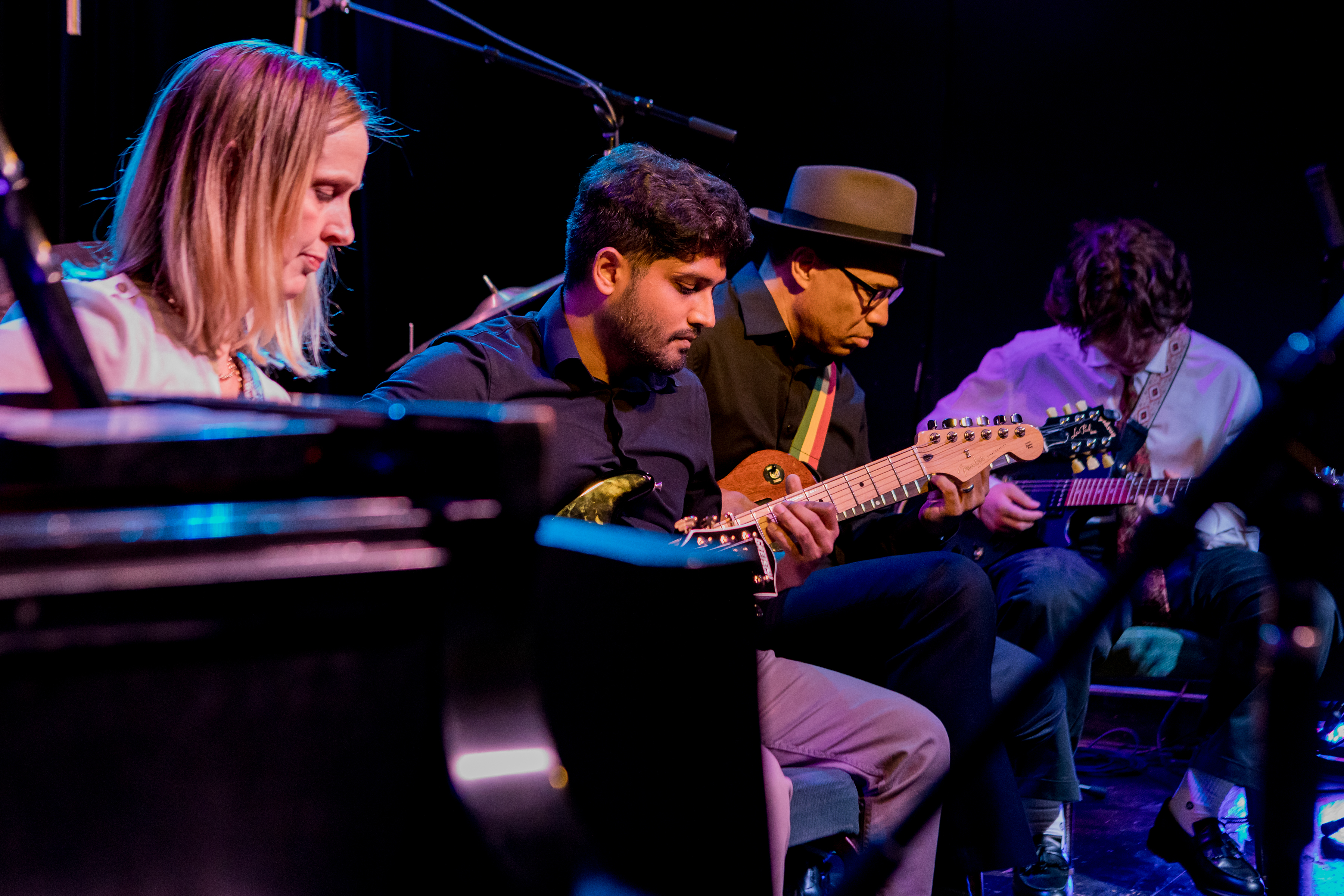 A JNS guitar ensemble performs on-stage.