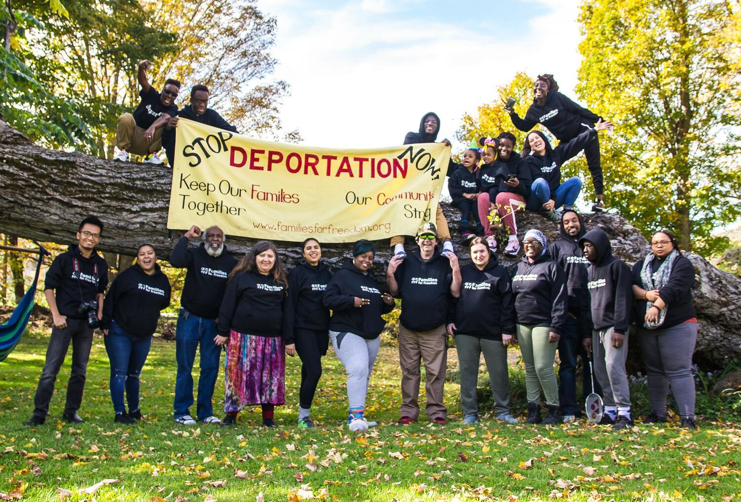 Families for Freedom members holding a sign reading "Stop deportation now"