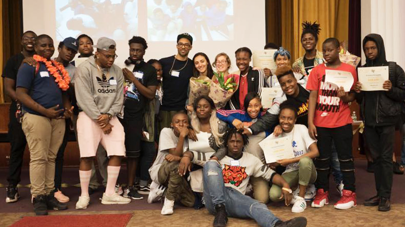 Students from diverse racial backgrounds gathered at an event, smiling for the camera