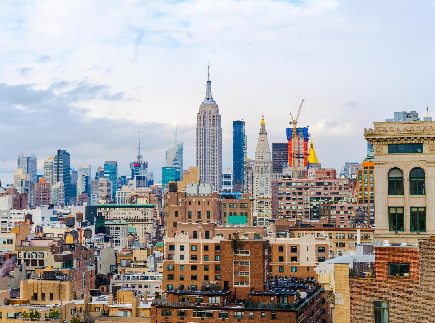 View of sky scrapers in New York with the Empire State Building in the center.