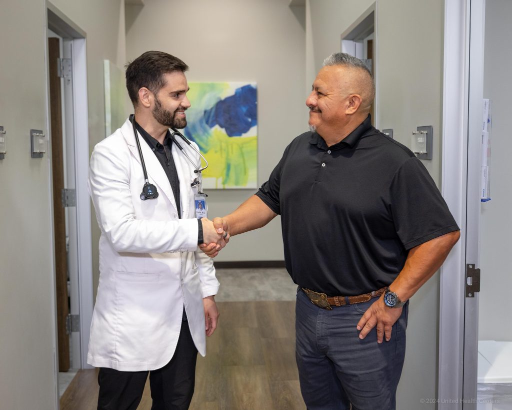 A medical provider shaking hands with a patient.