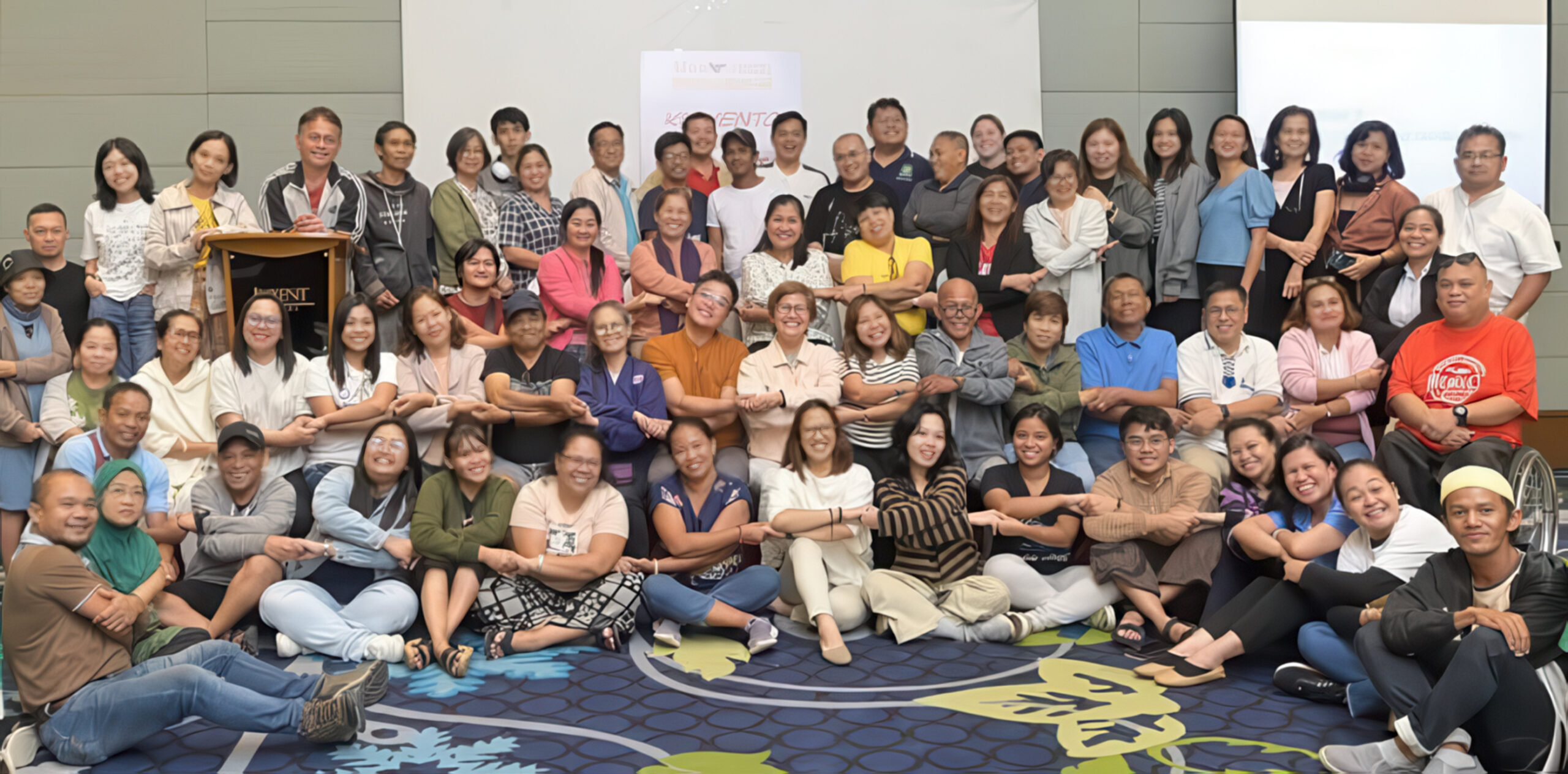 Group of people smiling and interlocking arms.