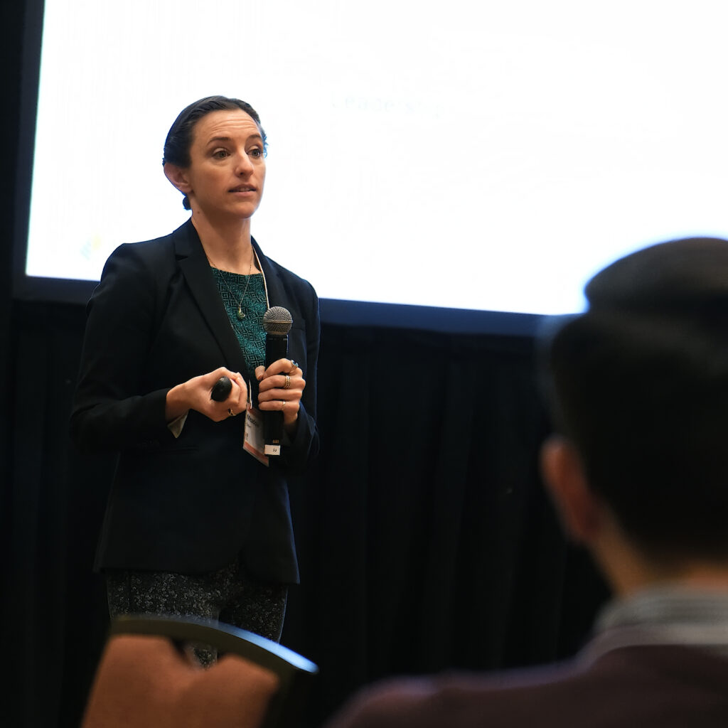 A speaker at an event holding a microphone